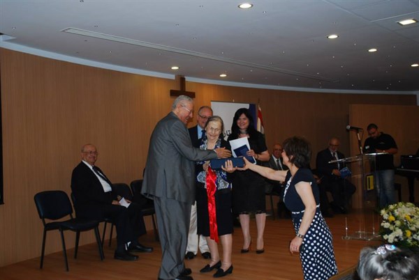 DMAH Publishing Manager, Ms. Sawsan Tannoury (back, right), presenting Pastor as-Sharouk's daughter with his Bible