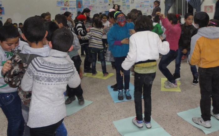 Syrian children engage happily in a silly game at a Child Friendly Space. (Photo: LSESD Staff)