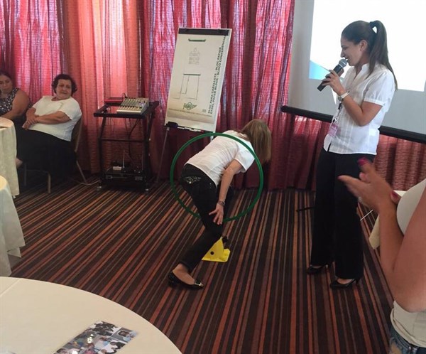  An occupational therapist demonstrating to teachers how our ability to "locate our bodies in space" impacts our ability to read and write.